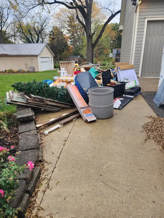 Dumpster being loaded with debris for Estate Cleanout Dumpster Rental in Lorain